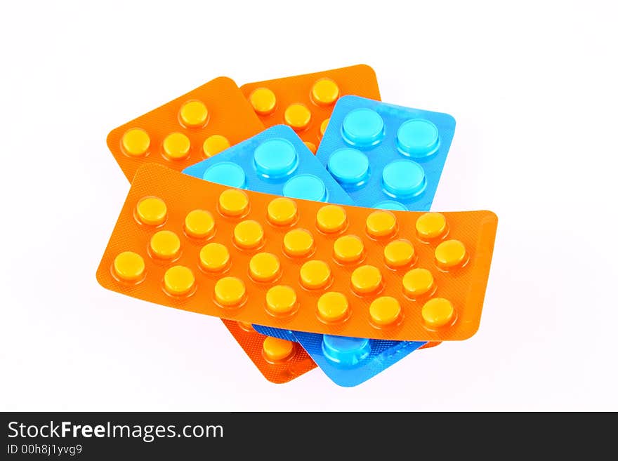 Tablets and vitamin pills in different shapes and colors. Tablets and vitamin pills in different shapes and colors