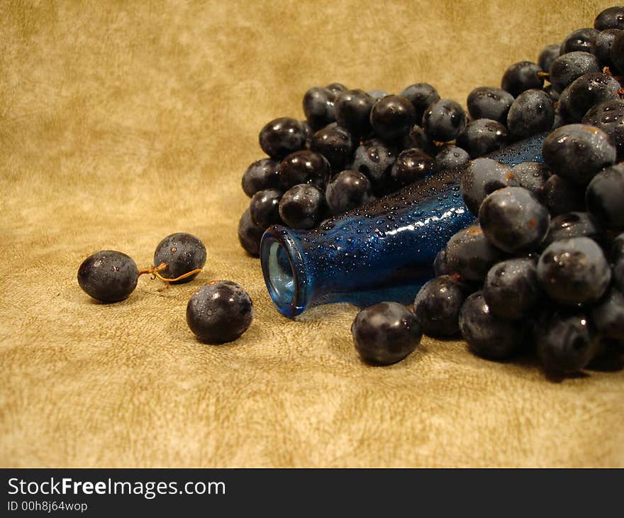 Black grapes and blue bottle