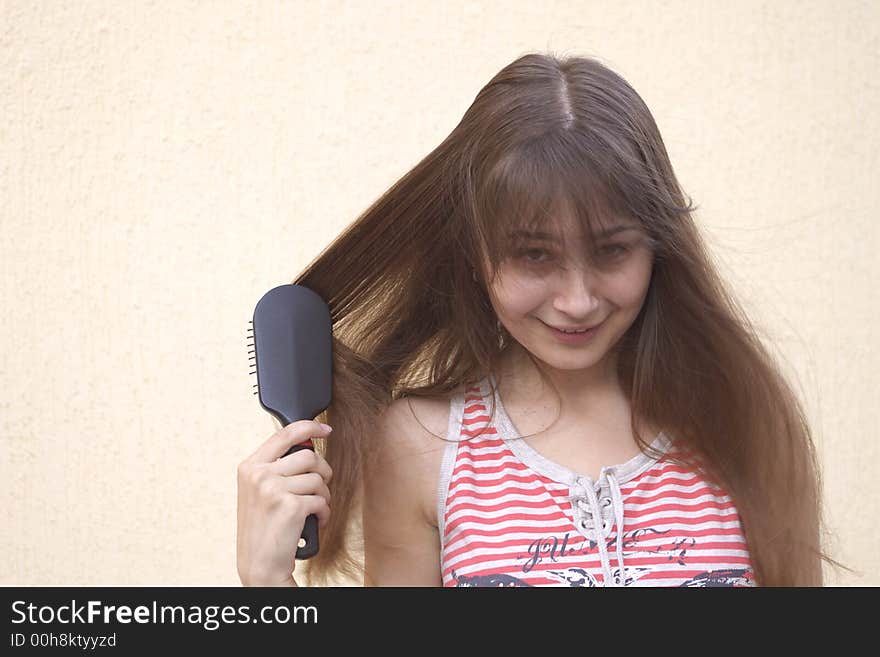 Young woman with hairbrush