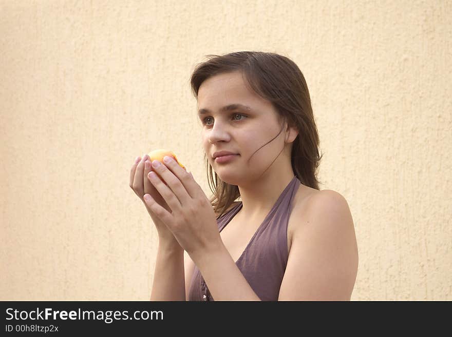 Young girl eating big juicy peach. Young girl eating big juicy peach