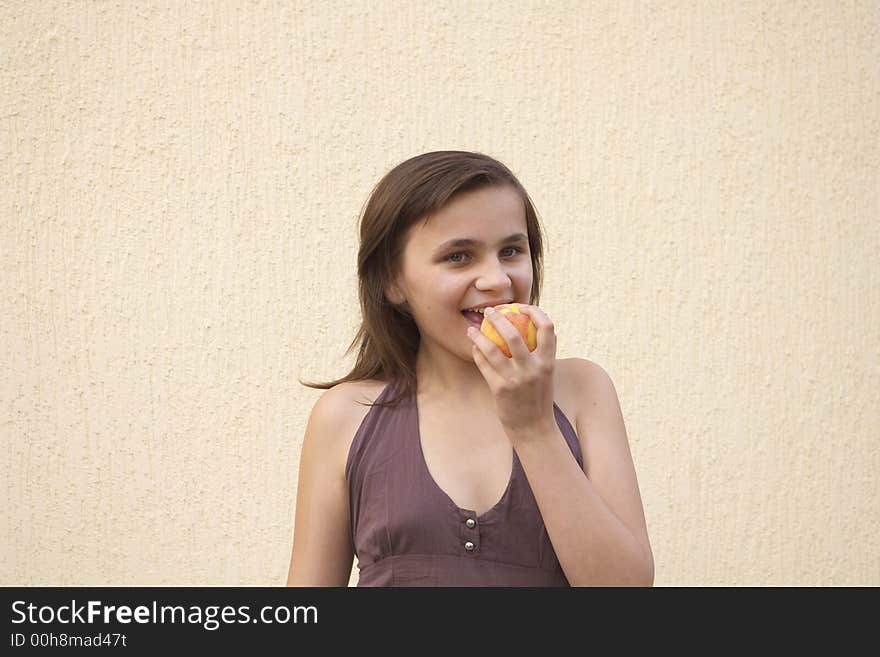 Girl eating big peach