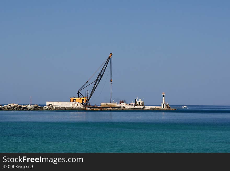 A crane on a pier, while working. A crane on a pier, while working