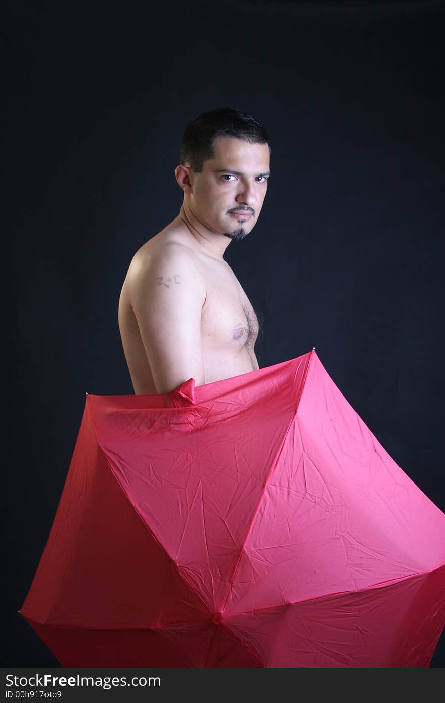 Portrait of a young man with red umbrella