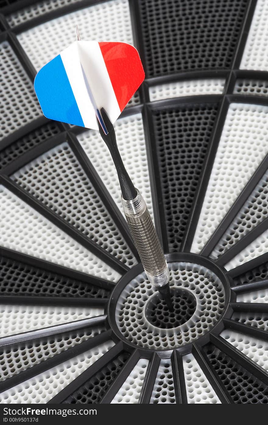 Dart in the colours of the french flag hits the bull's eye. Dart in the colours of the french flag hits the bull's eye