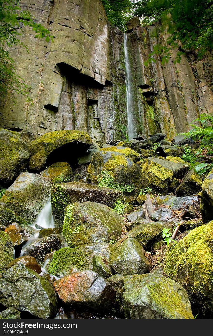 Twelve meters high waterfall on the hill in the Bohemian Middlemountains in the north of the Czech Republic. The small stream flow to the river Elbe. Twelve meters high waterfall on the hill in the Bohemian Middlemountains in the north of the Czech Republic. The small stream flow to the river Elbe.