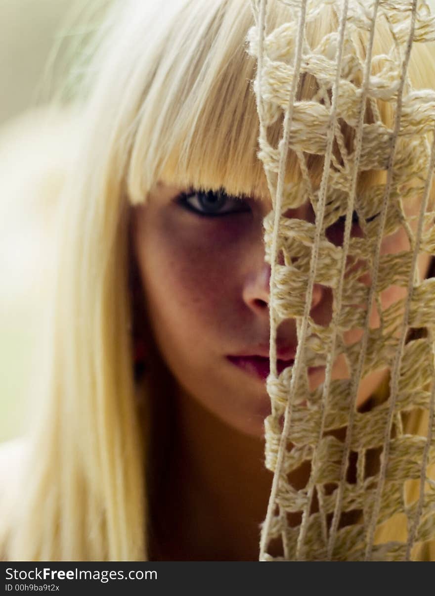 Blond woman s face behind net