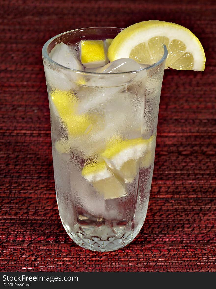 A glass of ice water with lemon. A glass of ice water with lemon