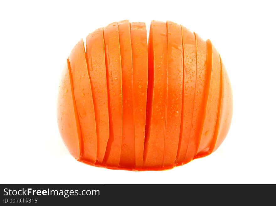 Sliced tomato with dewdrops on a white background