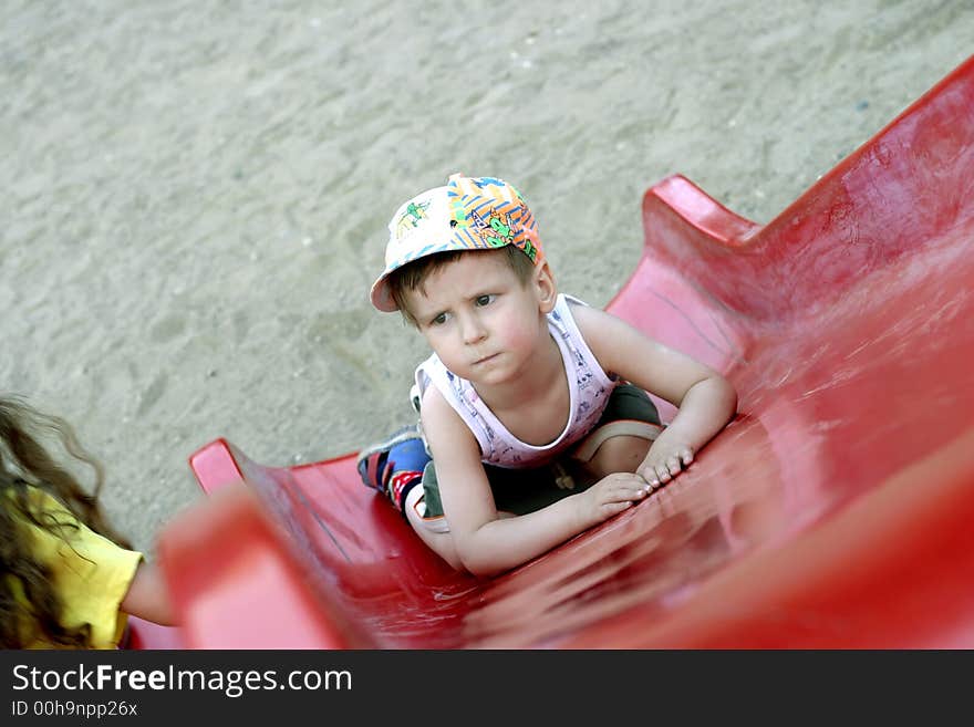 The little boy becomes angry, that cannot rise upwards on a children's hill