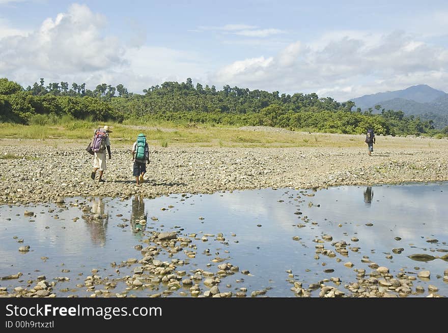 Three men hiking towards the Sierra Madre Mountains in Isabela, Philippines. Three men hiking towards the Sierra Madre Mountains in Isabela, Philippines