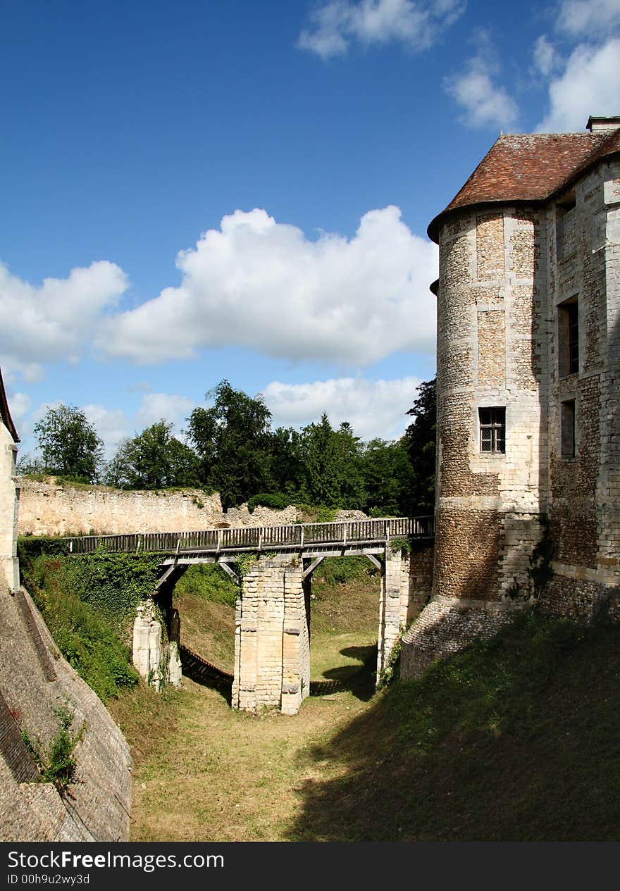 Drawbridge entrance over an empty Moat to a Fortified Chateau in Normandy, France. Drawbridge entrance over an empty Moat to a Fortified Chateau in Normandy, France