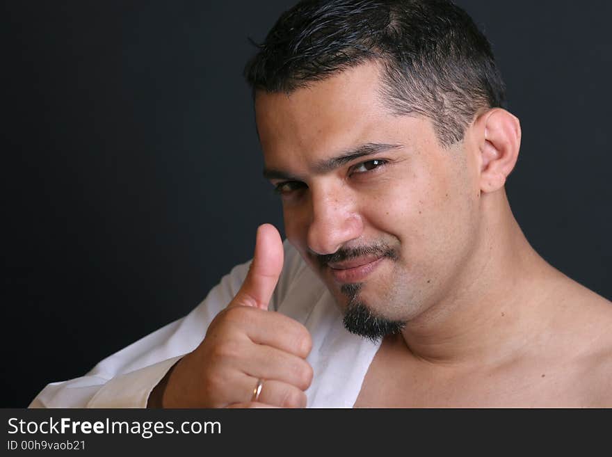 Portrait of a young man with thumb up. Portrait of a young man with thumb up