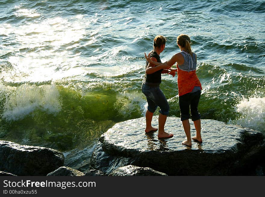 Two teenager girls catching waves near Lake Ontario. Two teenager girls catching waves near Lake Ontario