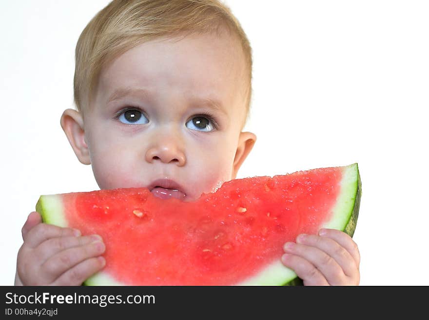 Image of cute toddler eating a big piece of watermelon. Image of cute toddler eating a big piece of watermelon