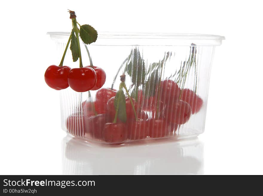 Fresh cherry in transparent packing on a white background