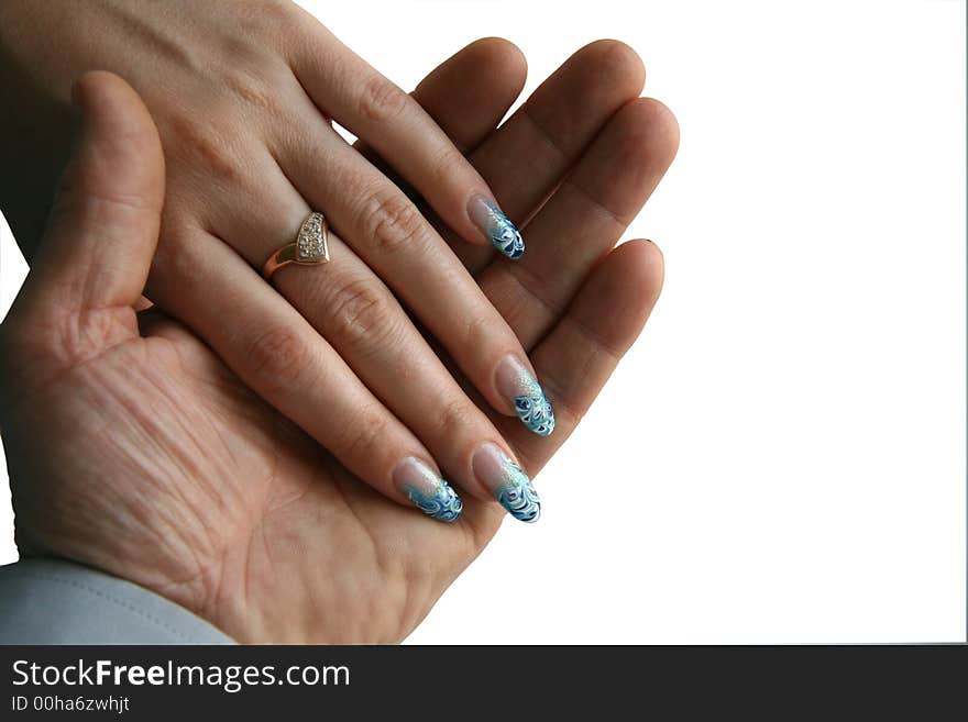 The female hand with manicure lays in a man's palm. The isolated image