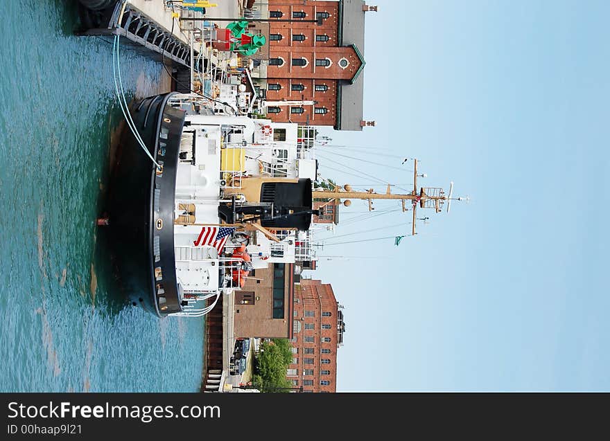 A Coast Guard vessel docked in the harbor, taking on tourists for inspection. A Coast Guard vessel docked in the harbor, taking on tourists for inspection.