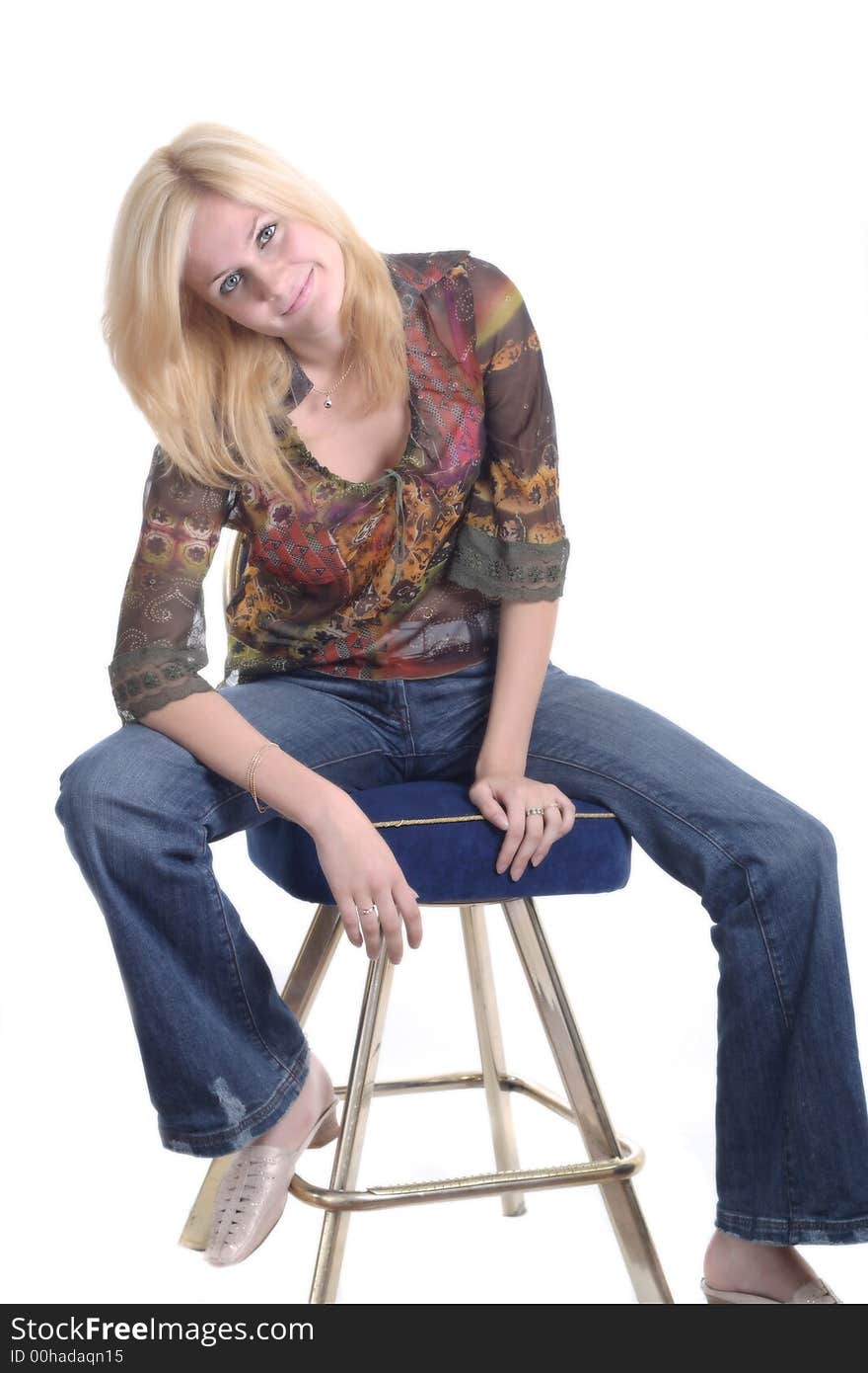 Beautiful blond girl sitting on the chair