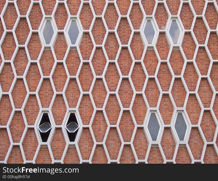 Exterior face of a 1960's brick building with honeycomb pattern facade. Exterior face of a 1960's brick building with honeycomb pattern facade