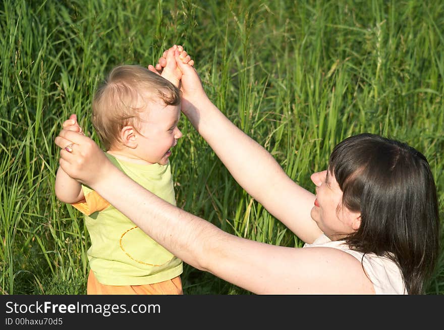 The happy mum and nice child play a nature. The happy mum and nice child play a nature