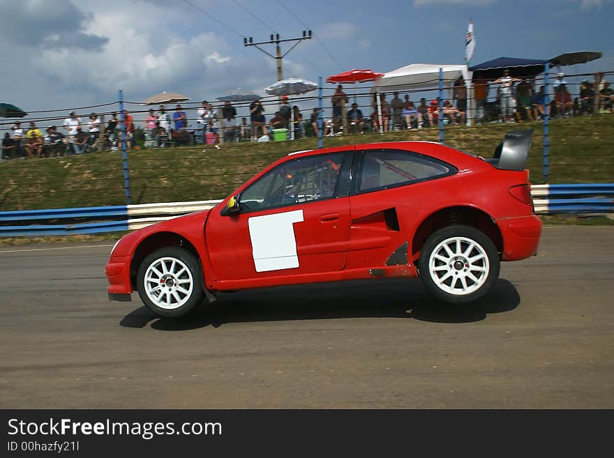 Rallycross car jumping on tarmac - logos removed. Rallycross car jumping on tarmac - logos removed