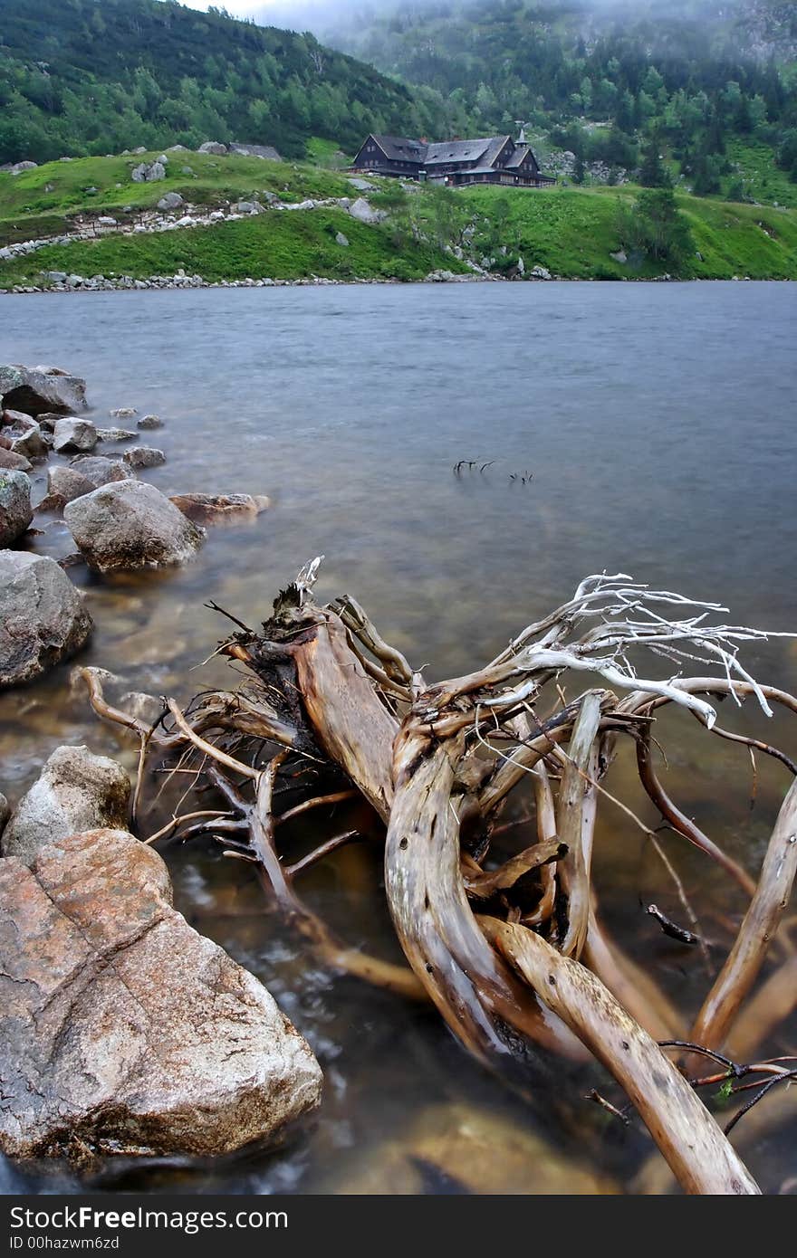 Windy foggy morning at lake in the Giant mountains (Czech Republic)