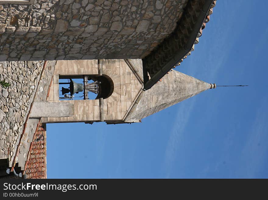 A french church tower with a bell