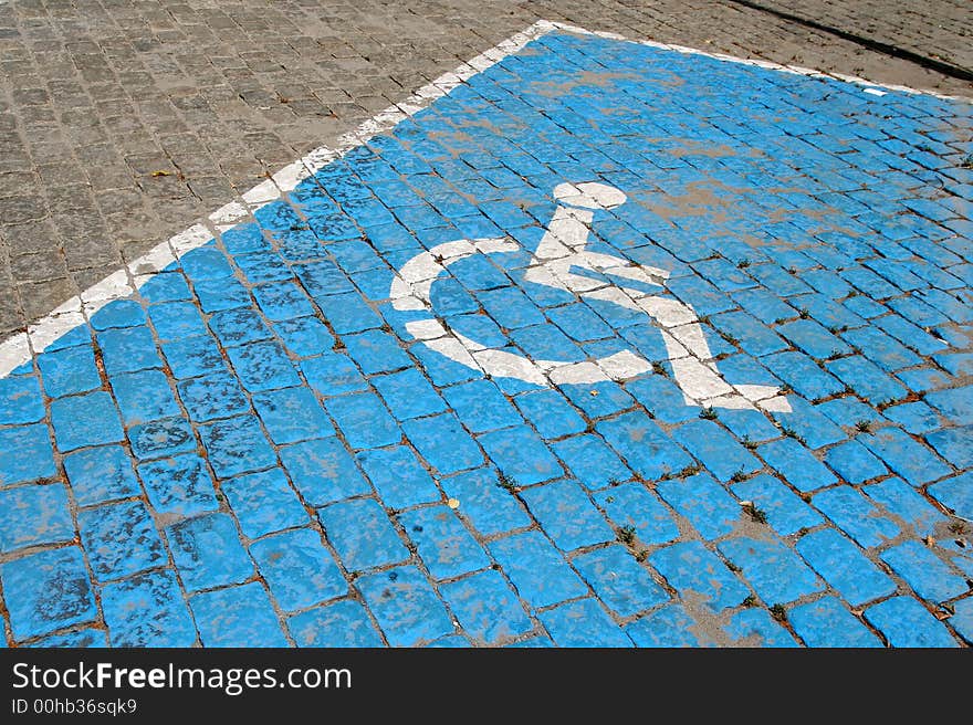 A slot for the handicapped in a car's parking lot. A slot for the handicapped in a car's parking lot