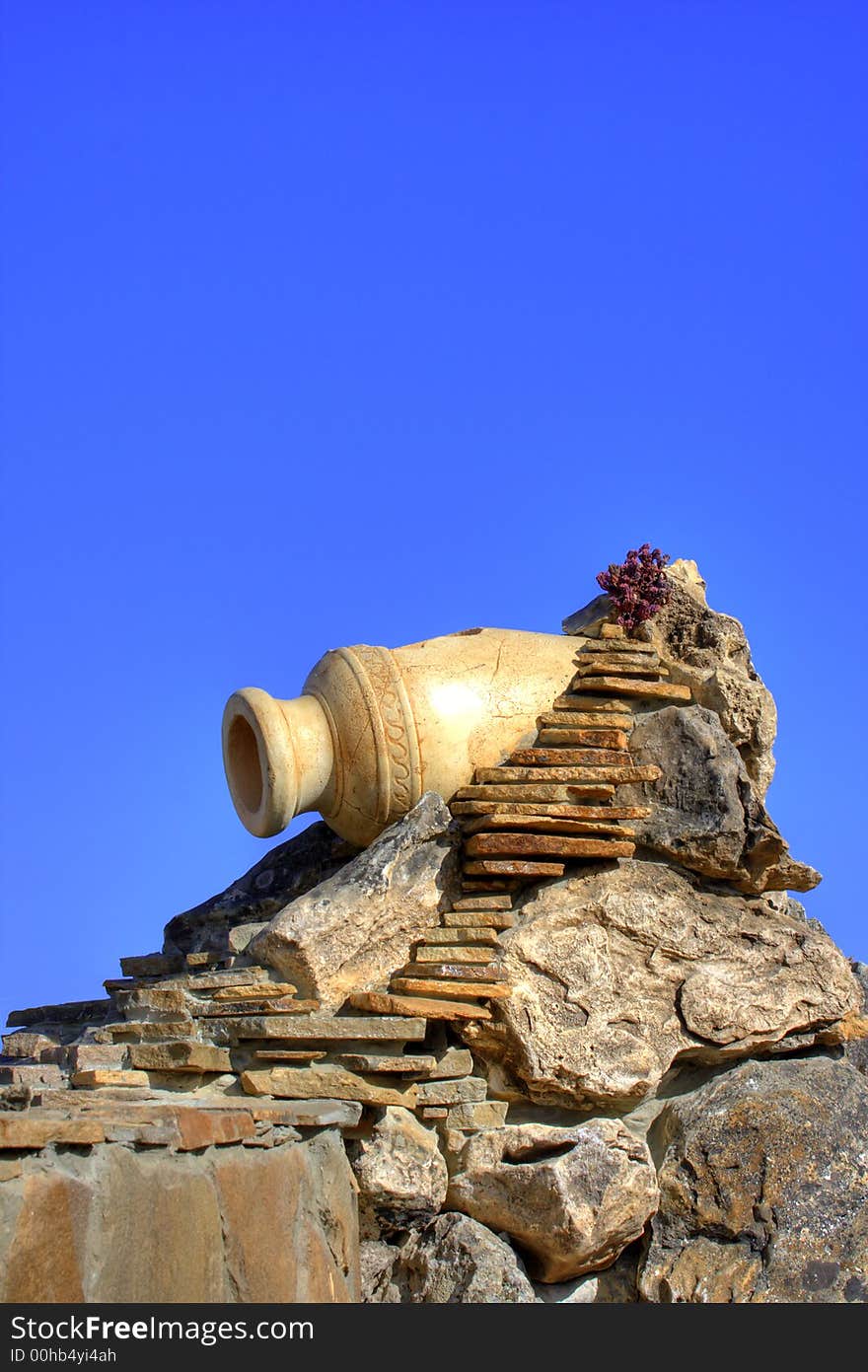 The dried up old source stylized under an antique amphora