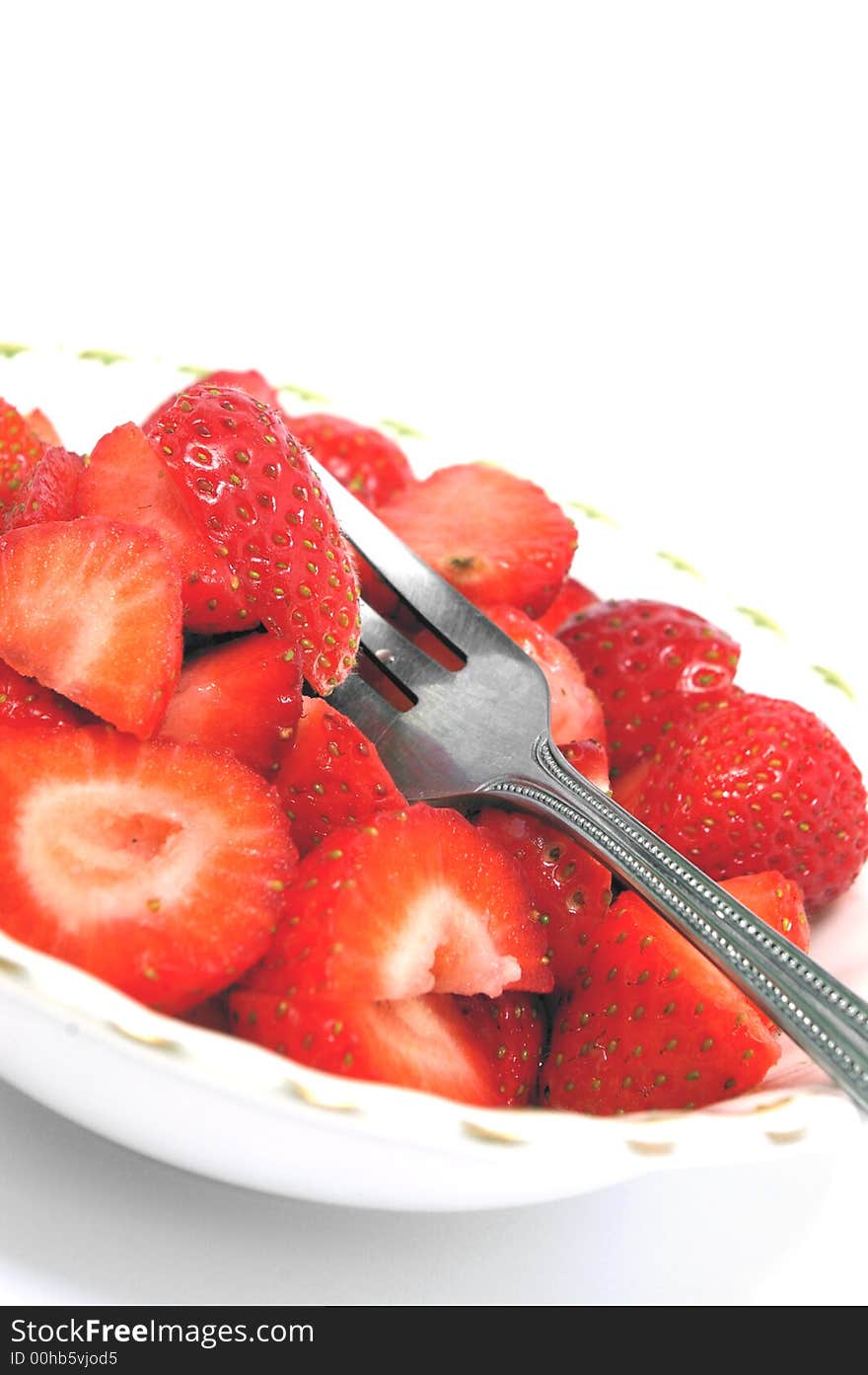 Cut strawberries in a bowl at a quirky angle. Cut strawberries in a bowl at a quirky angle.