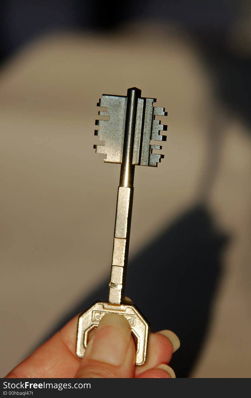 Woman holding a key in the sunlight. Woman holding a key in the sunlight