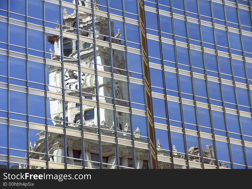 The clock of Chicago's Wrigley building reflected in a nearby office tower. The clock of Chicago's Wrigley building reflected in a nearby office tower.