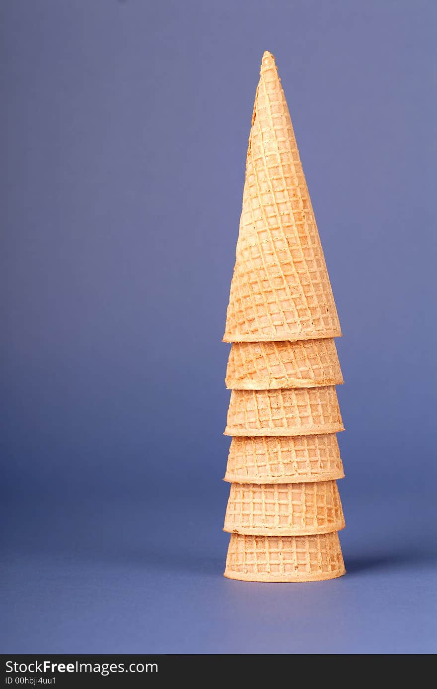 Stack of waffle icre cream cones on blue background. Stack of waffle icre cream cones on blue background