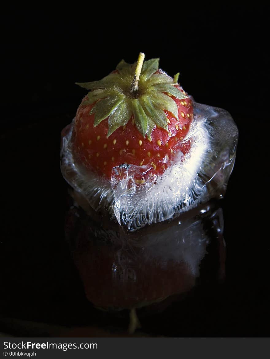 Red strawberry in icy cube