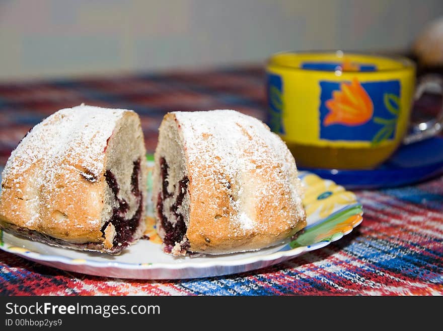 Fruit cake covered with icing sugar and tea