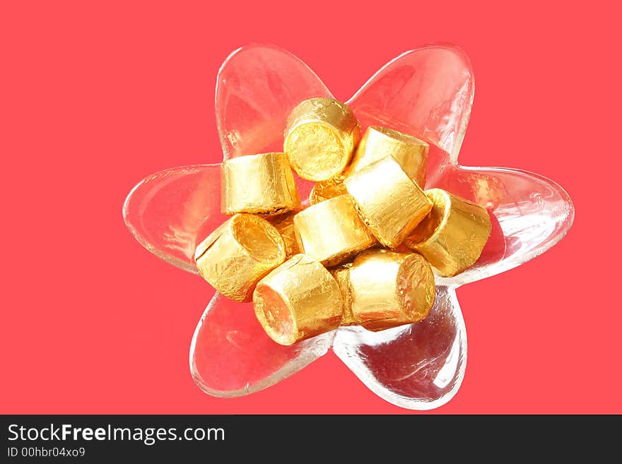 Fancy bowl of chocolates on red background