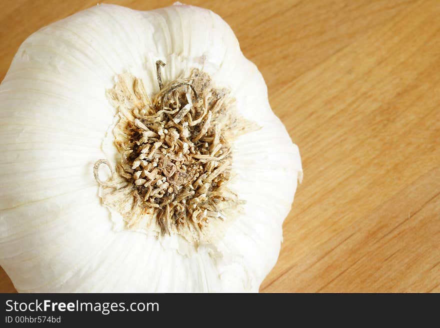 Organic garlic head over brown background. Organic garlic head over brown background