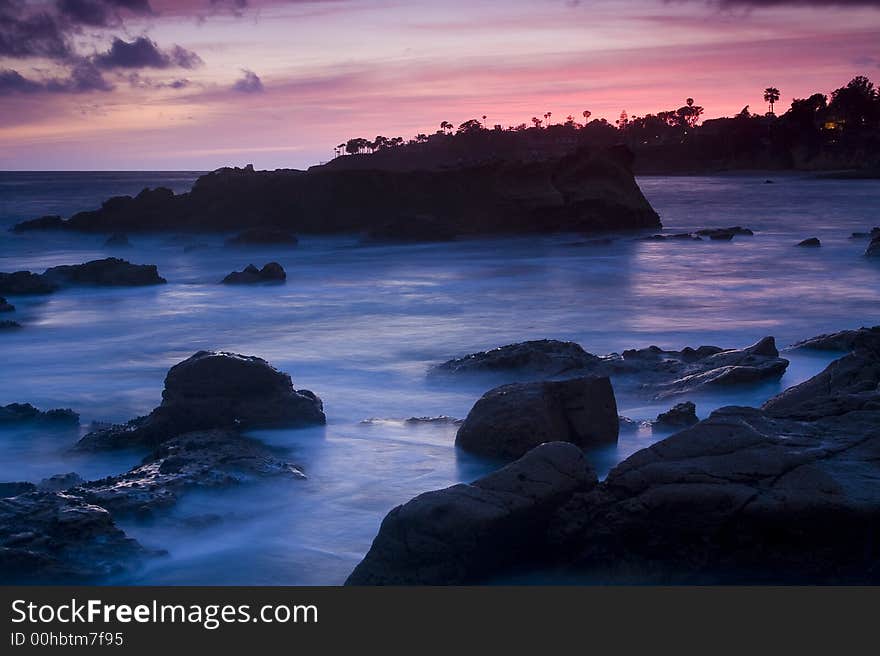 Pink evening skies over a misty coastline. Pink evening skies over a misty coastline