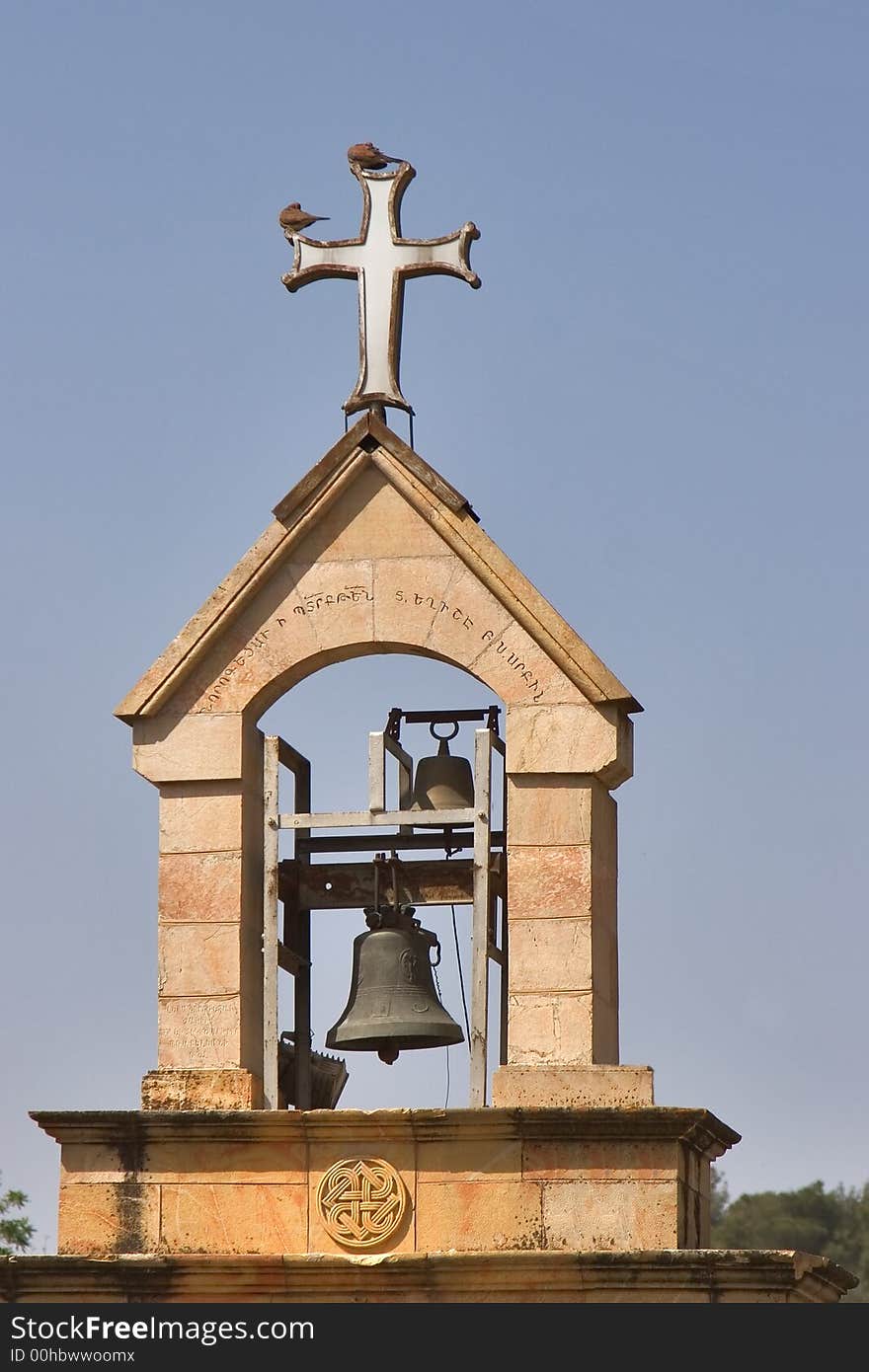 A belltower and a cross in old quarter of Jerusalem. A belltower and a cross in old quarter of Jerusalem