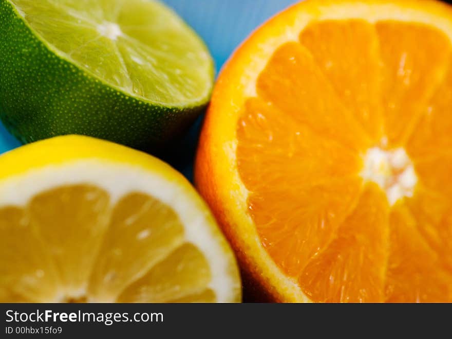 Close up of lime, orange and lemon cut in halves. Close up of lime, orange and lemon cut in halves.