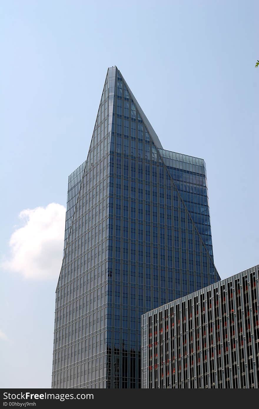 Blue glass office building with pyramid top. Blue glass office building with pyramid top