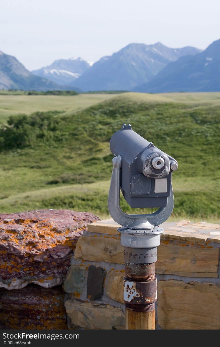 Telescope overlooking mountains at a view-point