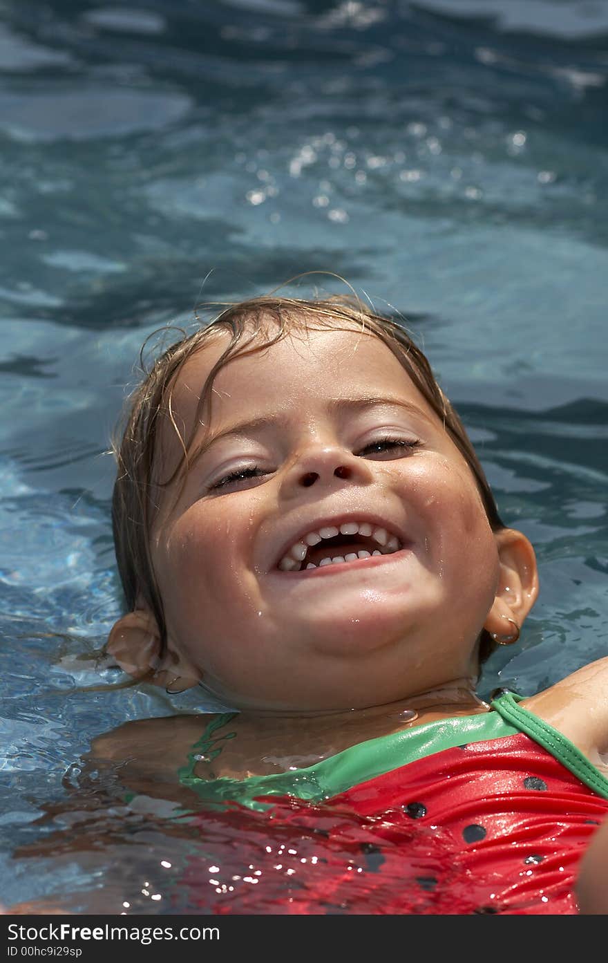 Young girl smiling in pool water. Young girl smiling in pool water