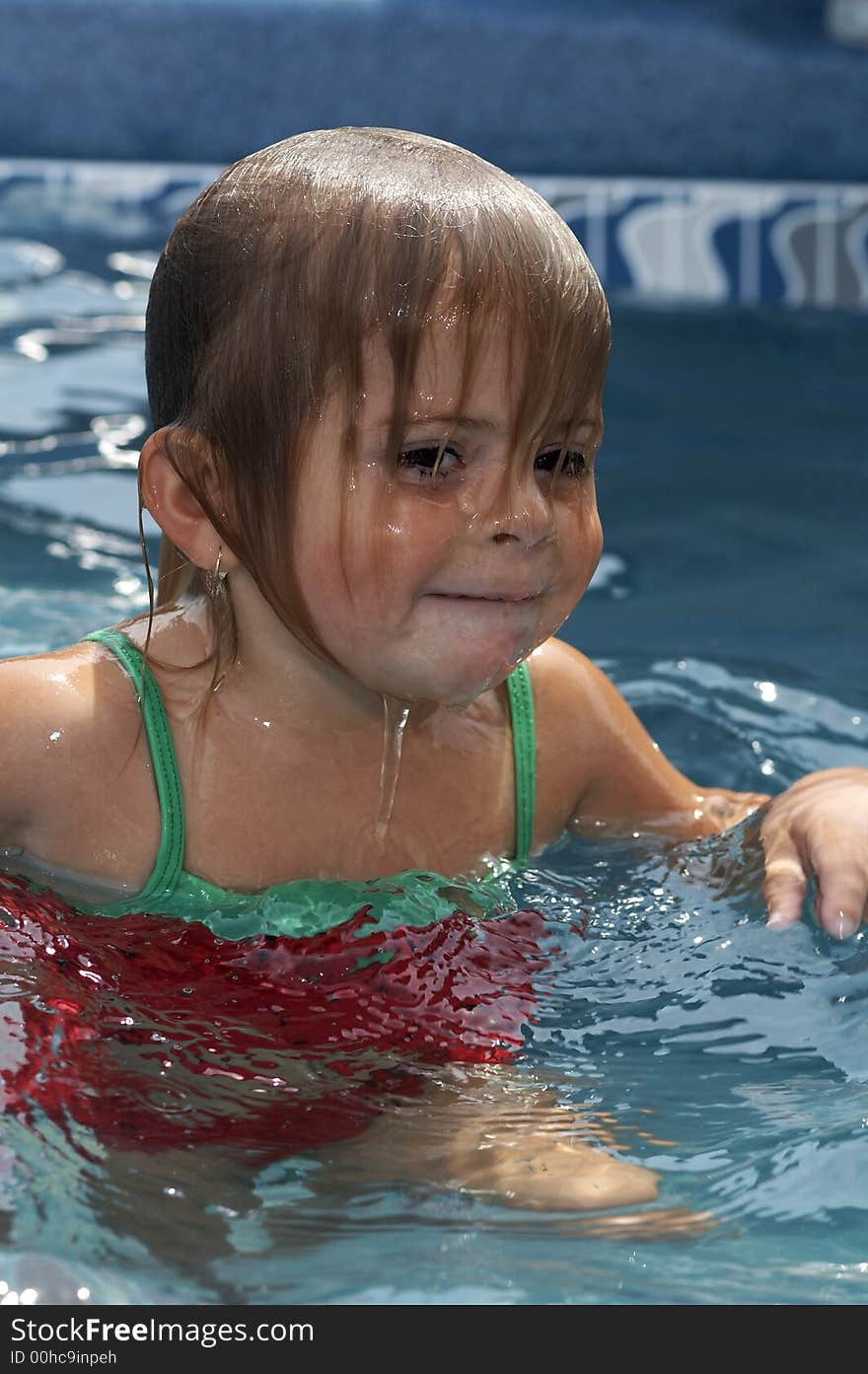 Young girl smiling in pool water. Young girl smiling in pool water