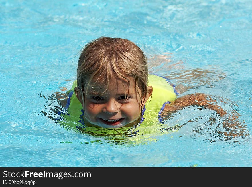 Young girl smiling in pool water. Young girl smiling in pool water