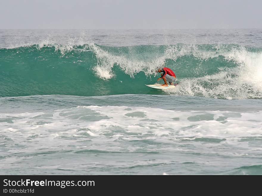 Surfer tucks into a barrel at Phuket in Thailand. Surfer tucks into a barrel at Phuket in Thailand