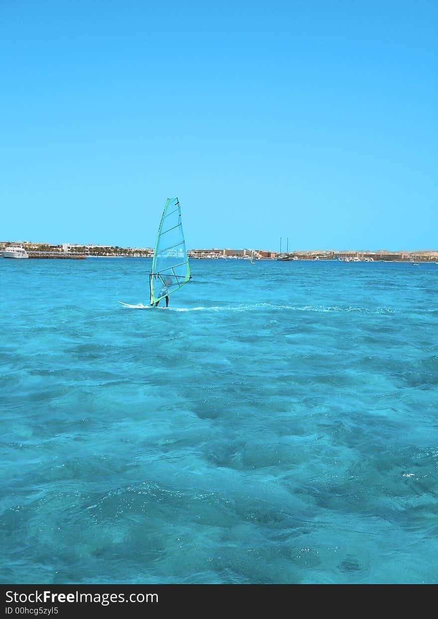 Windsurfer in blue sea, ocean