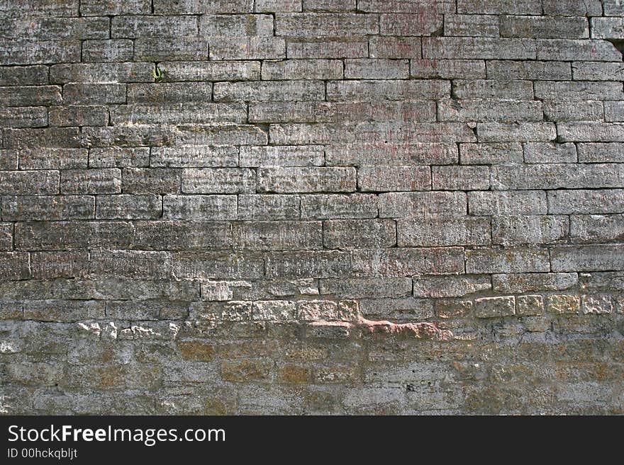 Obsolete castle brick wall as textured background. Obsolete castle brick wall as textured background