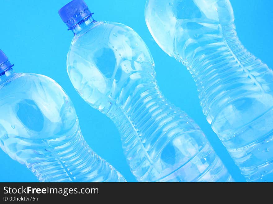 Mineral water pouring from a blue bottle