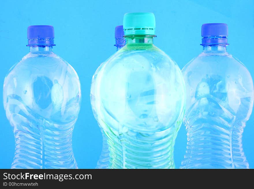 Mineral water pouring from a blue bottle